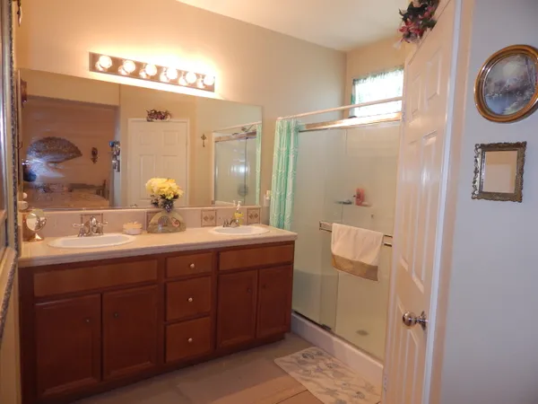 a bathroom with a double vanity sink and a mirror