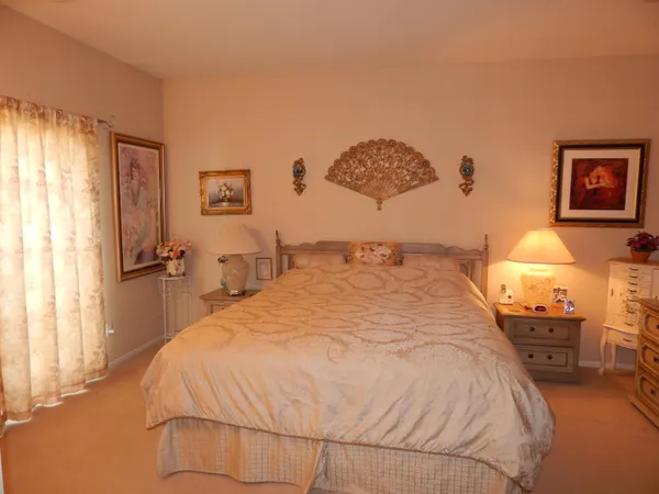 a bedroom with a bed and a lamp with window