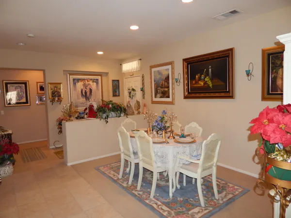 a dining room with furniture and flowers