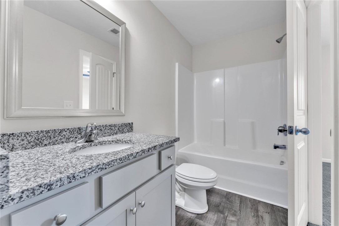 208 Samuel Street Pendleton, SC 29670 - Photo 19 of 32 Granite counters and a clean tub/shower combo elevate this refreshed bathroom.
