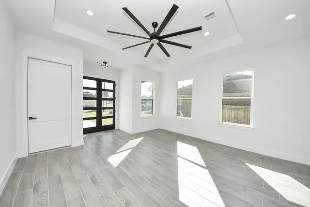 wooden floor in an empty room with a window
