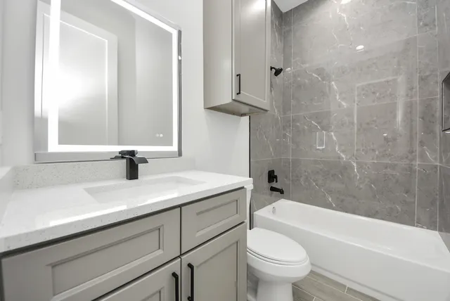 a bathroom with a sink a toilet and a bathtub