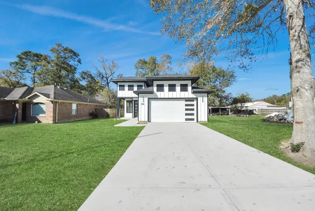 a front view of a house with a yard and a garage