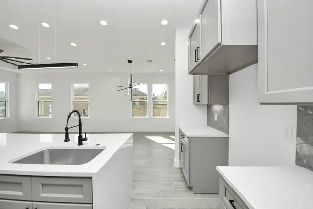 a kitchen with a sink stainless steel appliances and cabinets