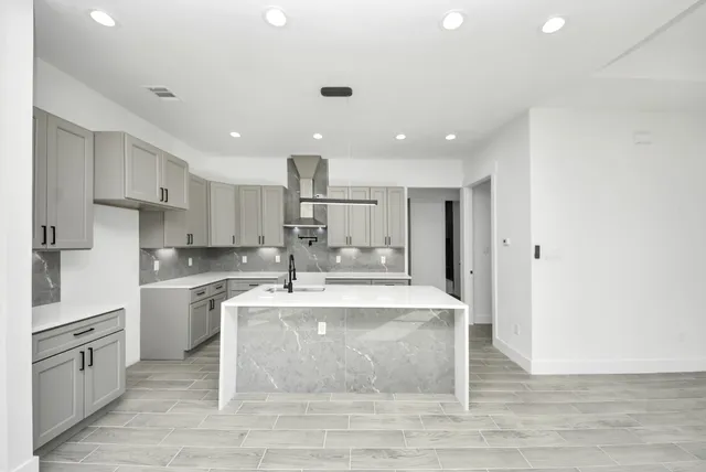 a view of kitchen with stainless steel appliances granite countertop refrigerator sink and stove