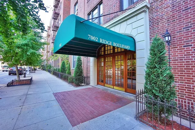a view of a patio with a table and chairs under an umbrella