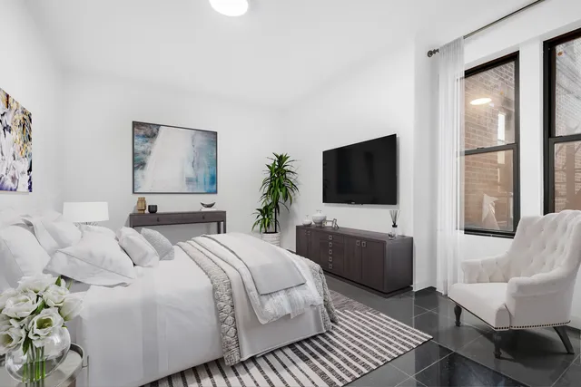 a bedroom with a bed and a flat screen tv