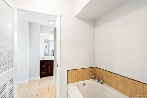 a bathroom with a tub and sink