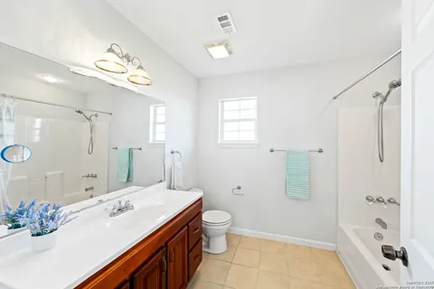 a spacious bathroom with a shower sink mirror and a bathtub