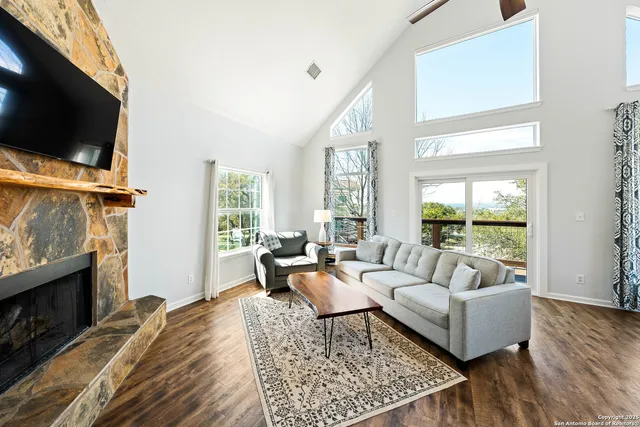 a living room with furniture a flat screen tv and a fireplace