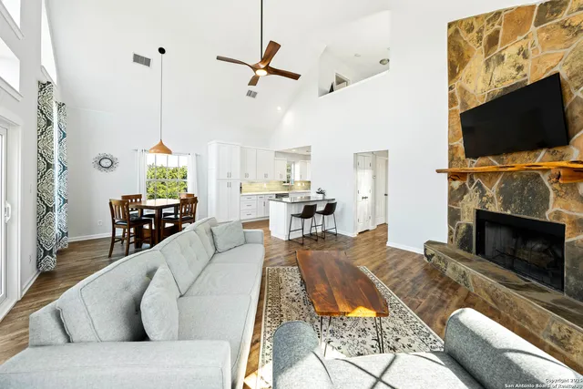 a living room with furniture fireplace and flat screen tv
