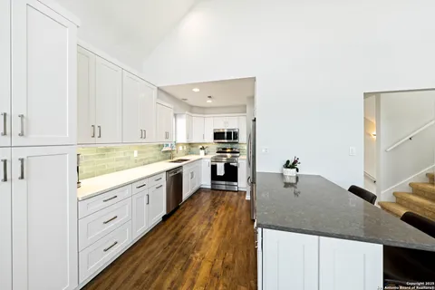 a large kitchen with white cabinets