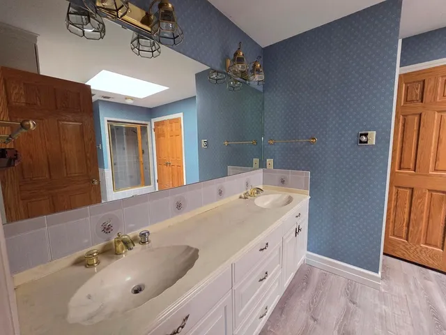 a bathroom with a double vanity sink and mirror