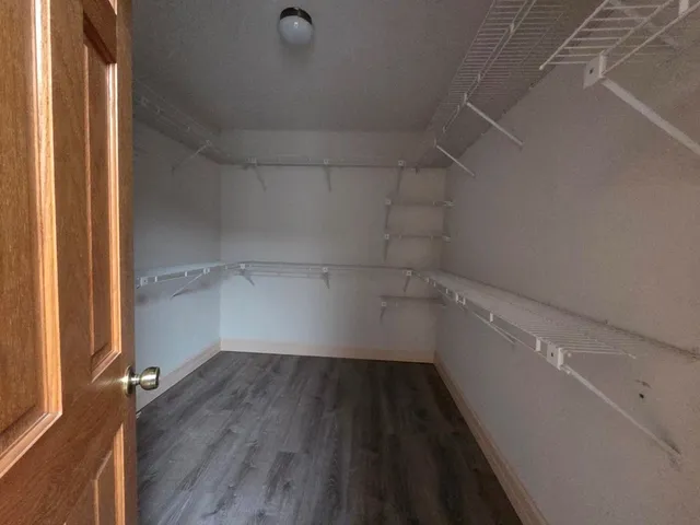 a view of a room with wooden floor