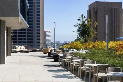 a view of swimming pool with outdoor seating and city view