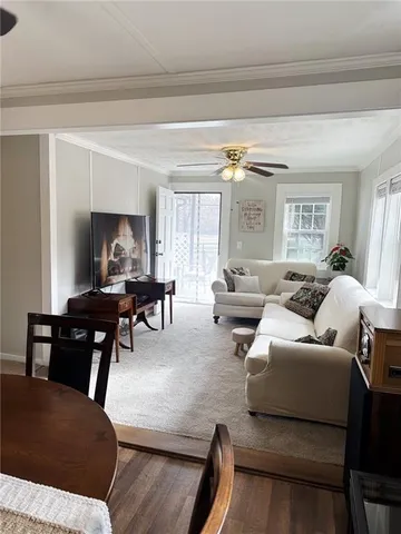 a kitchen with a refrigerator and white cabinets