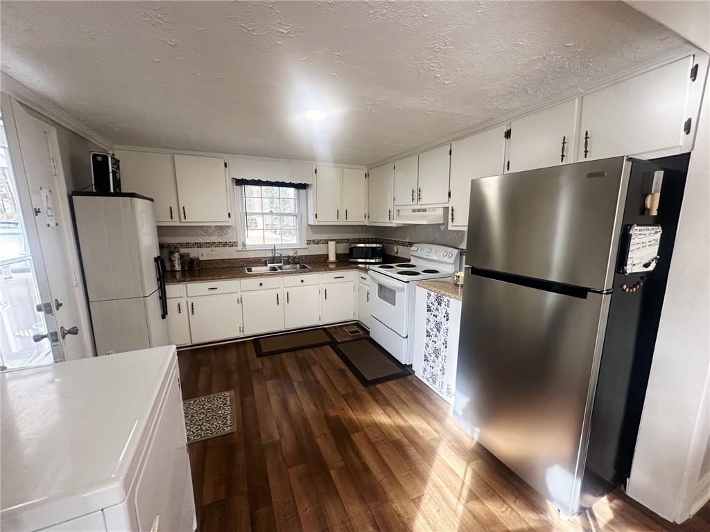 158 Rabbit Hill Road Dacula, GA 30019 - Photo 18 of 64 a kitchen with stainless steel appliances a refrigerator sink and stove
