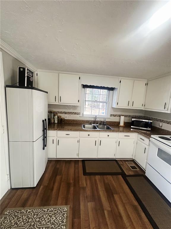 158 Rabbit Hill Road Dacula, GA 30019 - Photo 20 of 64 a kitchen with a refrigerator and white cabinets