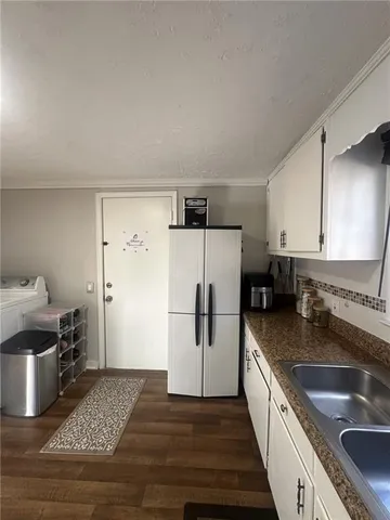 a bathroom with a double vanity sink toilet mirror and shower