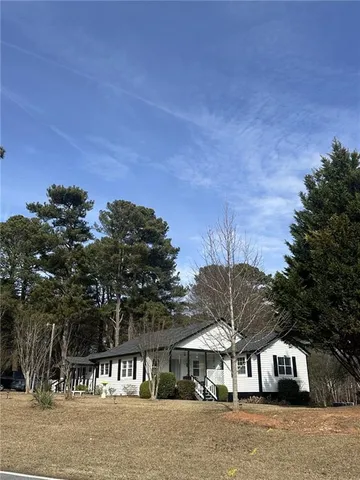 a view of a house with a chairs in patio