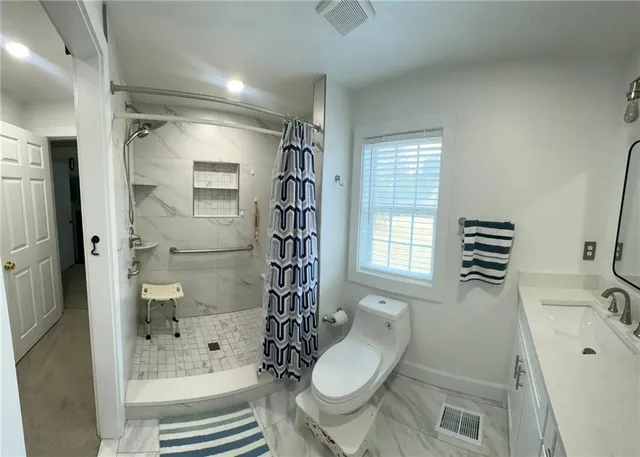 a bathroom with a tub a sink and a window