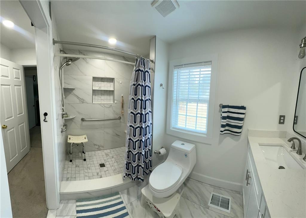 158 Rabbit Hill Road Dacula, GA 30019 - Photo 31 of 64 a bathroom with a sink toilet and shower