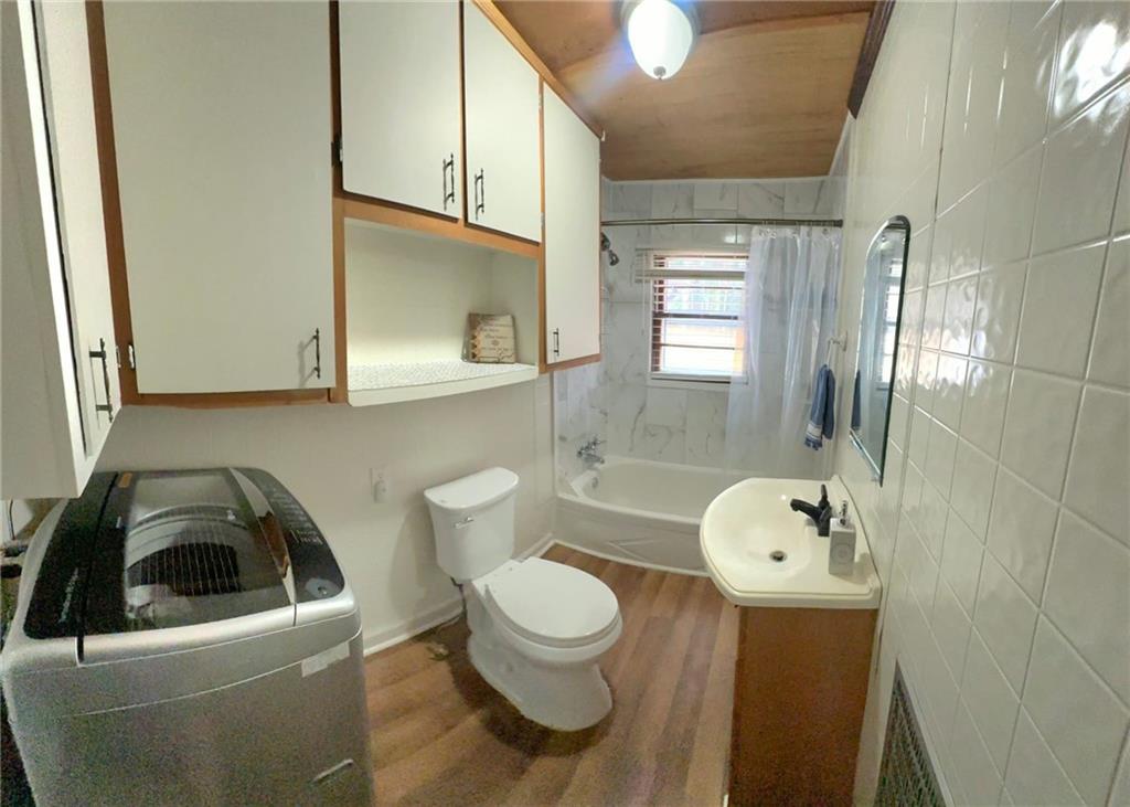 158 Rabbit Hill Road Dacula, GA 30019 - Photo 46 of 64 a bathroom with a toilet sink and mirror