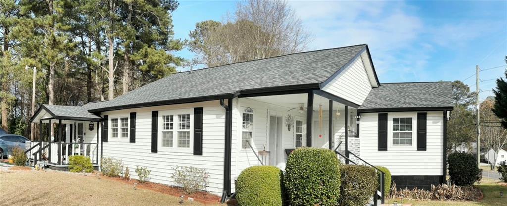 158 Rabbit Hill Road Dacula, GA 30019 - Photo 5 of 64 a view of a house with a chairs in patio