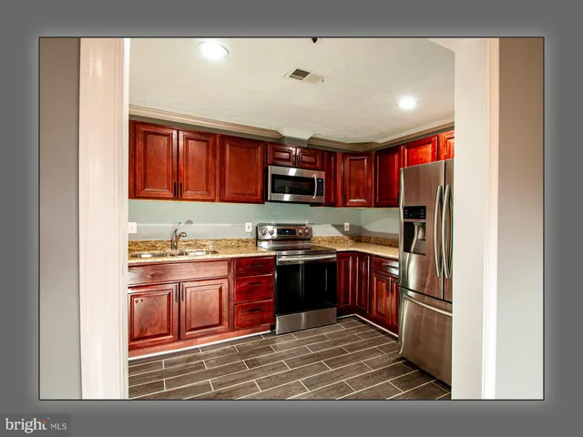 a kitchen with a refrigerator and a sink