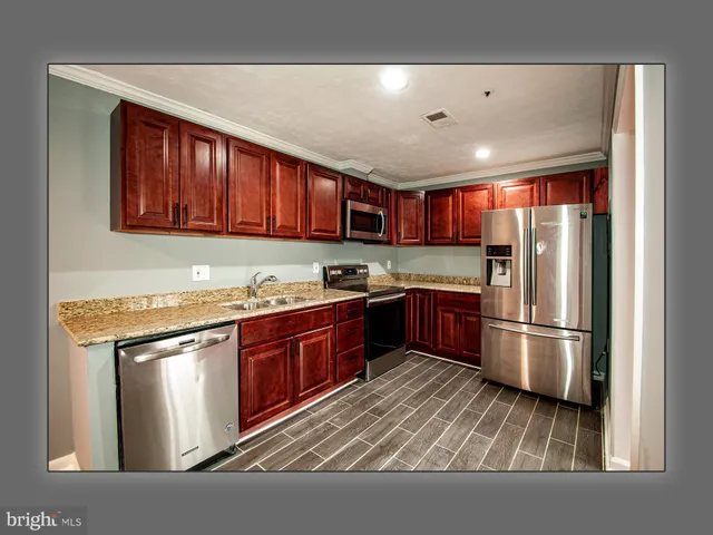 a kitchen with microwave a stove and cabinets