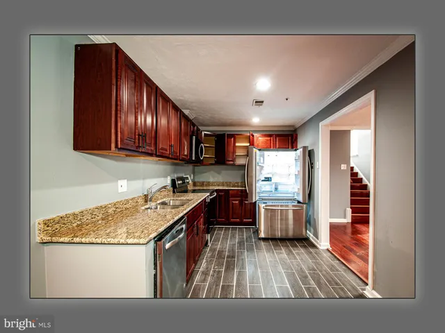 a kitchen with wooden cabinets and a stove top oven