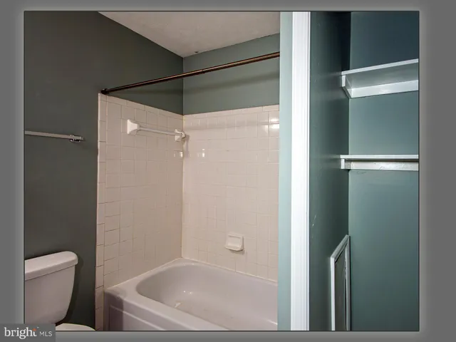 an empty room with wooden floor and closet