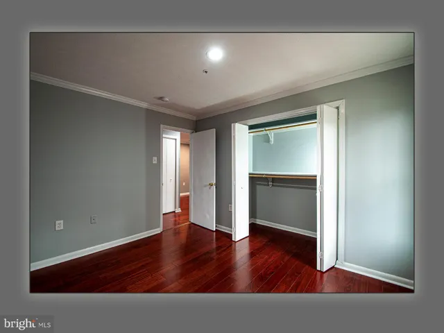 a bathroom with a granite countertop sink a mirror and a toilet