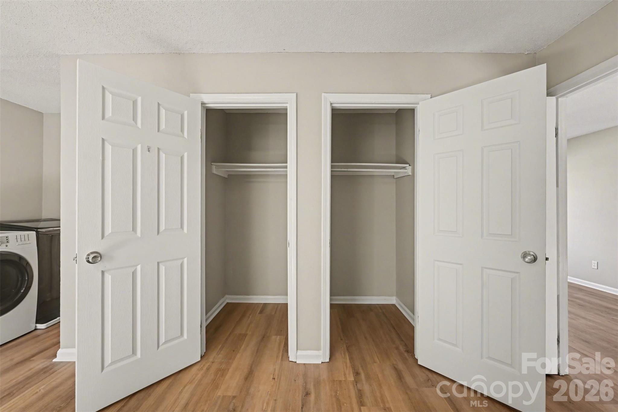 270-272 Spring Street Southwest Concord, NC 28025 - Photo 11 of 26 a view of walk in closet with wooden floor