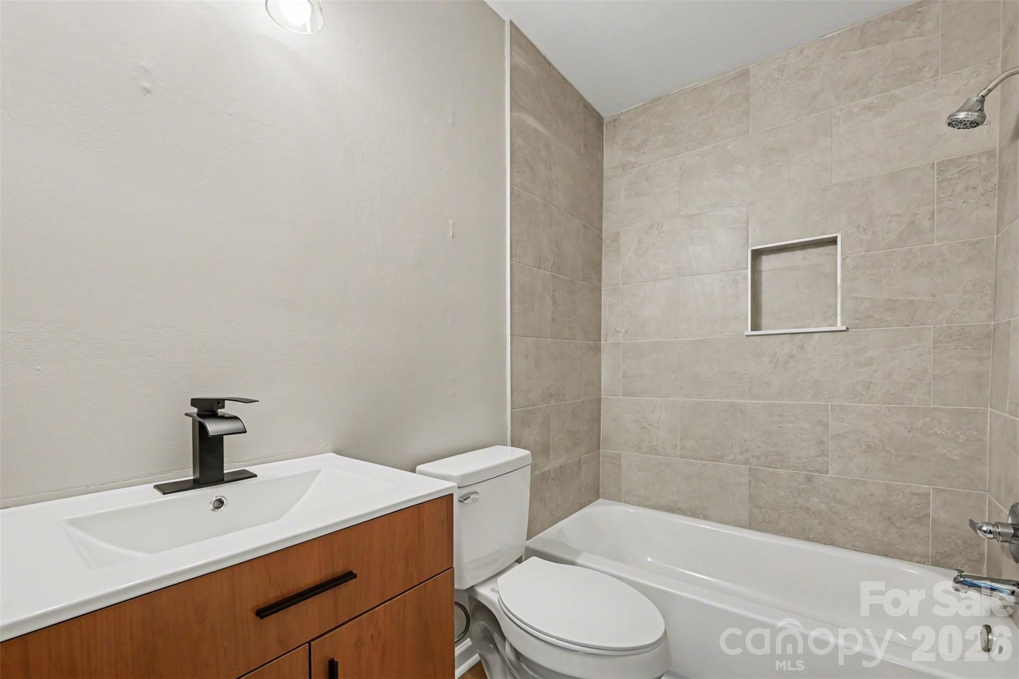 270-272 Spring Street Southwest Concord, NC 28025 - Photo 13 of 26 a bathroom with a sink a toilet and shower