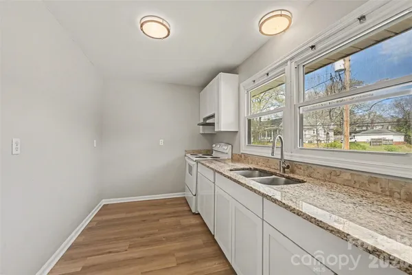 a kitchen with granite countertop a sink and a window