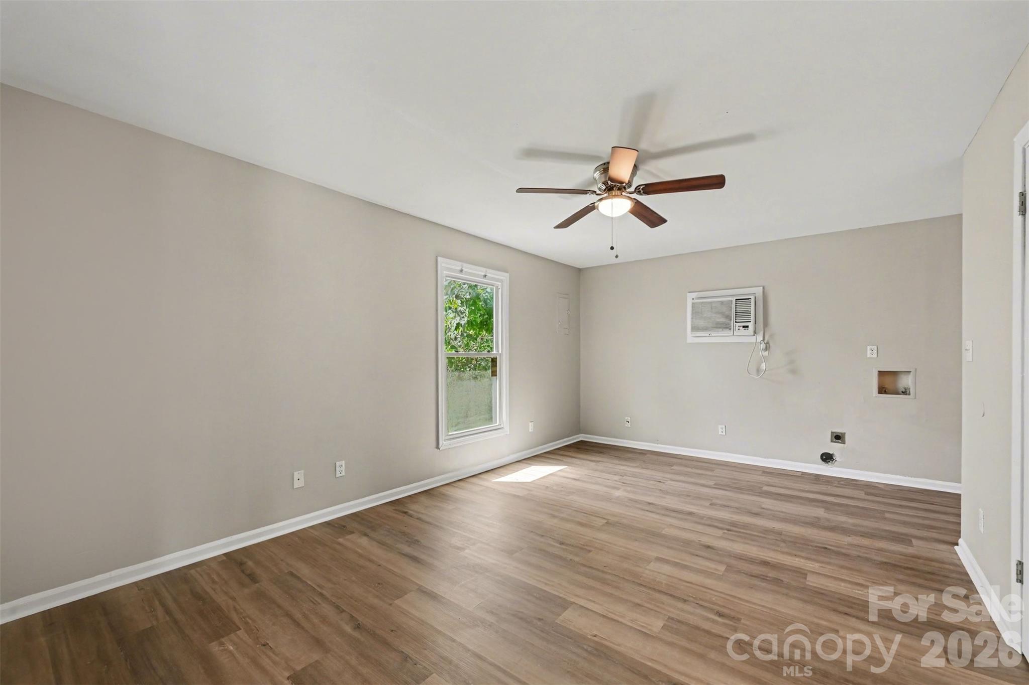 270-272 Spring Street Southwest Concord, NC 28025 - Photo 19 of 26 wooden floor in an empty room with a window