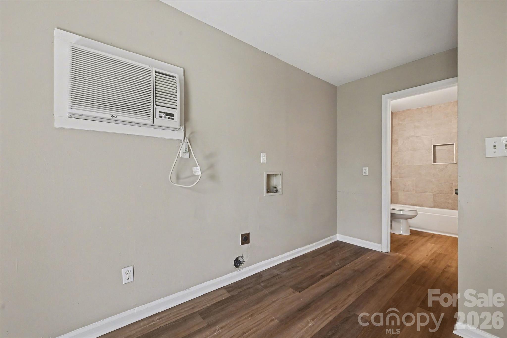 270-272 Spring Street Southwest Concord, NC 28025 - Photo 21 of 26 a view of an empty room with wooden floor and a bathroom