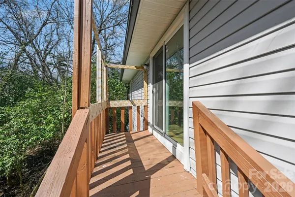 a view of balcony with wooden floor and fence