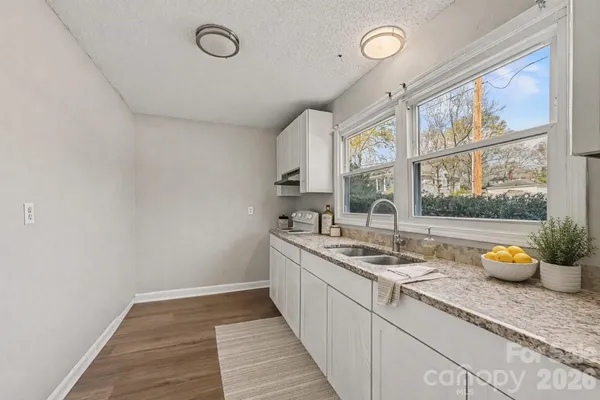 a kitchen with a sink and wooden cabinets