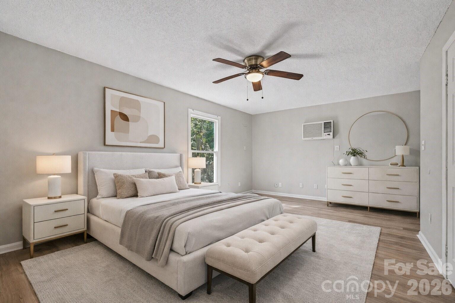 270-272 Spring Street Southwest Concord, NC 28025 - Photo 8 of 26 a bedroom with a large bed and a chandelier