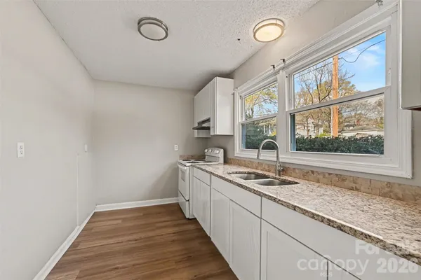 a kitchen with a sink and wooden cabinets