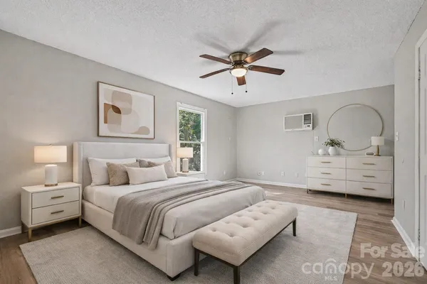 a bedroom with a large bed and a chandelier