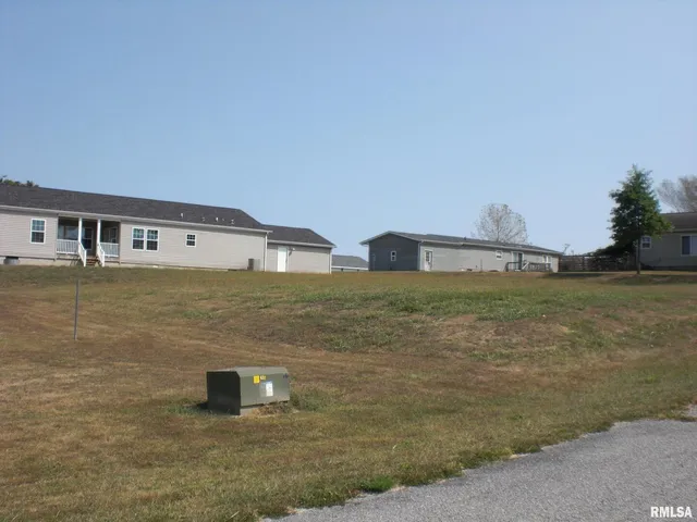 a view of residential houses with outdoor space and ocean view