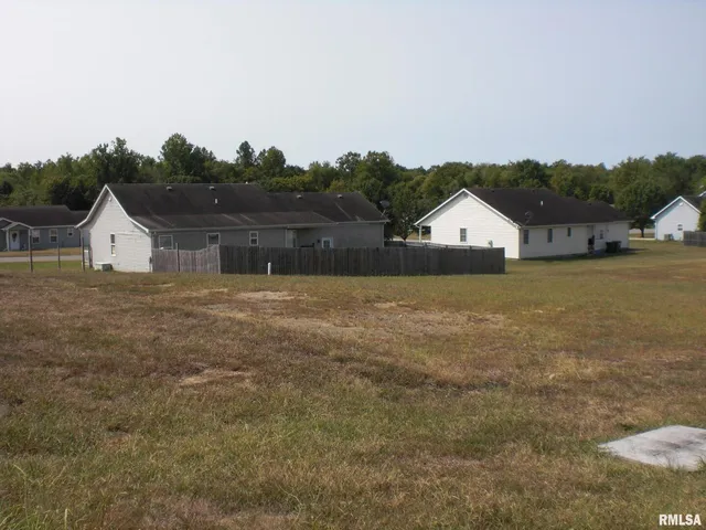 a view of house with yard and lake view