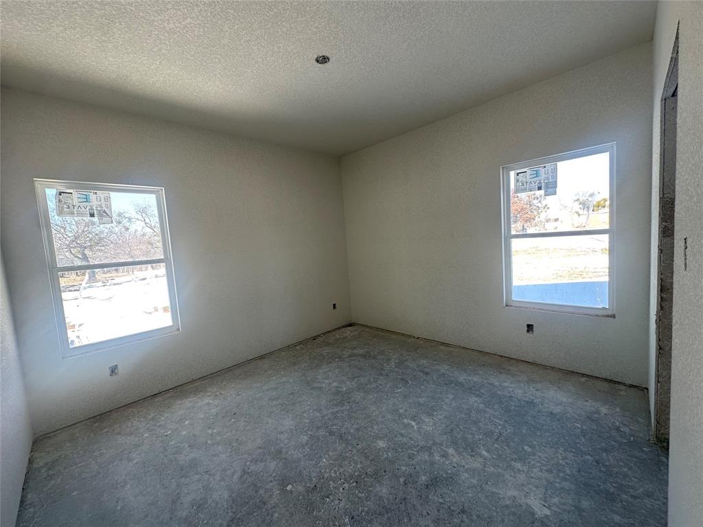 518 Strong Street Bowie, TX 76230 - Photo 11 of 14 an empty room with a window