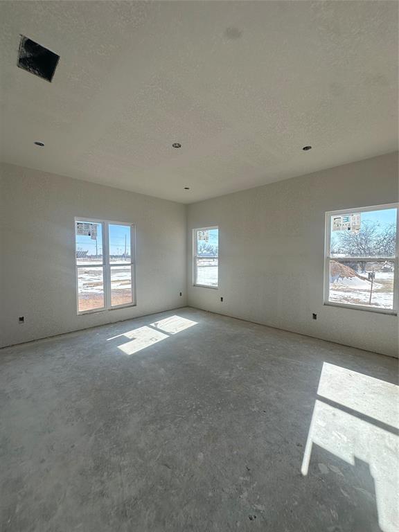 518 Strong Street Bowie, TX 76230 - Photo 5 of 14 a view of a big room with windows