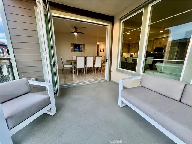 a balcony with furniture and a gate