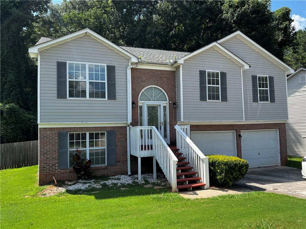a front view of a house with a yard and porch