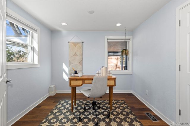 a workspace with wooden floor and a window